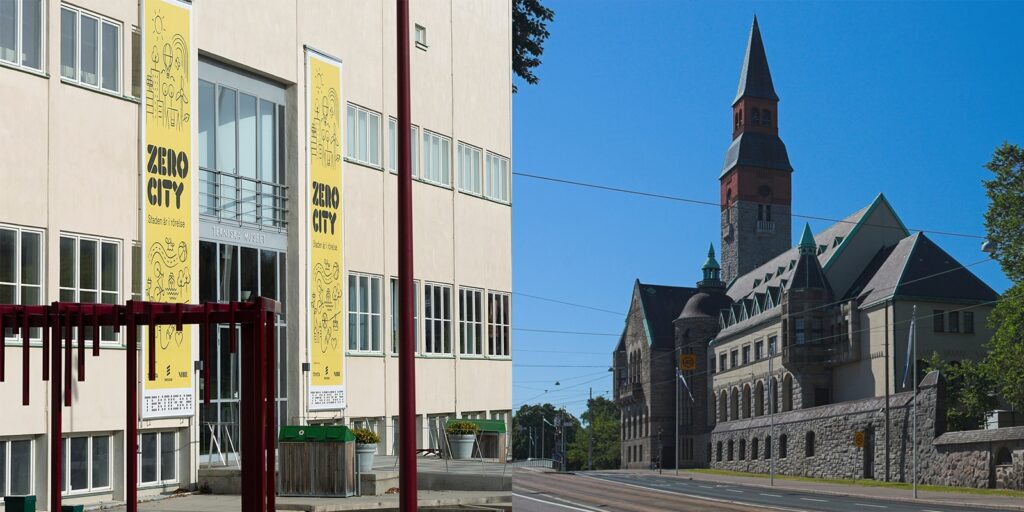 Byggnad visar två stora gula banderoller med texten "ZERO CITY".