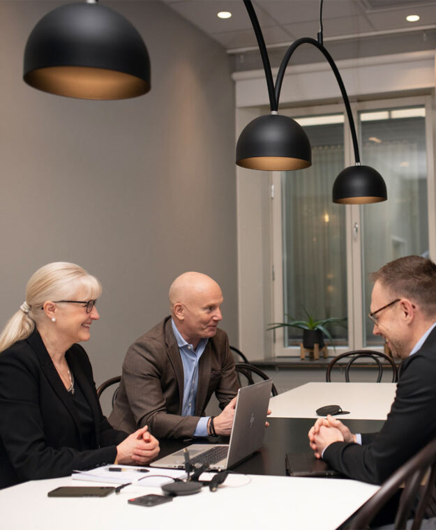Två män och två kvinnor sitter i ett möte.